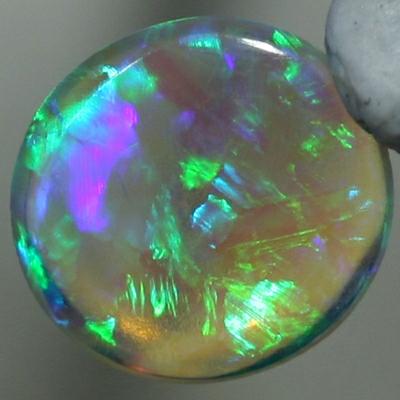 SOLID CRYSTAL OPAL Sparkles of green show in a Chaff pattern, totally clean body.